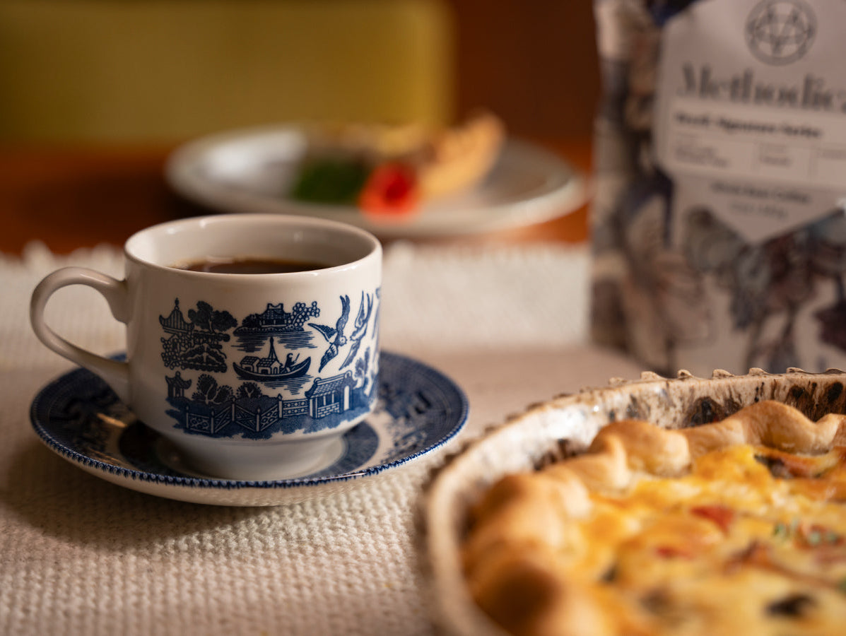 A cup of coffee paired with a quiche
